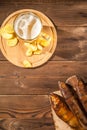 Beer glass with beer and hot smoked fish close-up. Beer mug with beer and potato chips, crackers on a dark background and copy spa Royalty Free Stock Photo