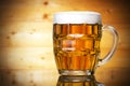 Beer glass isolated on wooden background Royalty Free Stock Photo