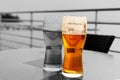 Beer glass lager golden drink contrast one of many on a gray background of a street cafe Royalty Free Stock Photo