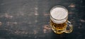 Beer in a glass mug. On a black wooden table. Royalty Free Stock Photo