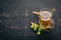 Beer in a glass mug. On a black wooden table. Royalty Free Stock Photo