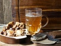 Beer glass mug with beer and shish kebab on the background of a kitchen cutting board