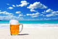 Beer in a glass mug on a white sand beach background Royalty Free Stock Photo