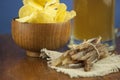 Beer glass with beer and smoked fish close-up. Beer mug with beer and potato chips, crackers on a wood background and copy space Royalty Free Stock Photo