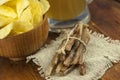 Beer glass with beer and smoked fish close-up. Beer mug with beer and potato chips, crackers on a wood background and copy space Royalty Free Stock Photo