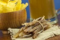 Beer glass with beer and smoked fish close-up. Beer mug with beer and potato chips, crackers on a wood background and copy space Royalty Free Stock Photo