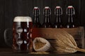 Beer glass on table with crate full of bottles Royalty Free Stock Photo