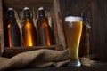 Beer glass with wooden crate full of beer bottles Royalty Free Stock Photo