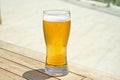 Beer in glass on wooden table. Cold beer on desk Royalty Free Stock Photo