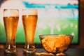 beer glasses and chips in front of tv - watching world cup football at home - soccer supporters Royalty Free Stock Photo