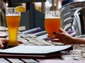 Beer glasses with froth on a restaurant table with golden amber color on a hot summer day