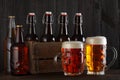 Beer glasses on table with crate full of bottles Royalty Free Stock Photo