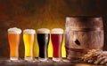 Beer glasses with a wooden barrel.