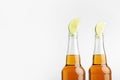 Beer with lemon. Bright lager in bottles isolated on white background Royalty Free Stock Photo