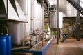 Beer manufacture line. Equipment for staged production bottling of Finished food products. Metal structures, pipes and tanks at en Royalty Free Stock Photo