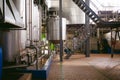 Beer manufacture line. Equipment for staged production bottling of Finished food products. Metal structures, pipes and tanks at en Royalty Free Stock Photo