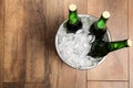 Beer in metal bucket with ice on background, top view. Space for text Royalty Free Stock Photo