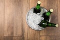 Beer in metal bucket with ice on background, top view. Space for text Royalty Free Stock Photo