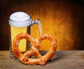 Beer Mug with German Pretzel on wooden table. isolated Royalty Free Stock Photo