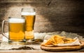 Beer in mug, glass on wooden table Royalty Free Stock Photo