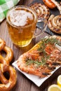 Beer mug, grilled shrimps, sausages and pretzel Royalty Free Stock Photo