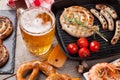 Beer mug, grilled shrimps, sausages and pretzel Royalty Free Stock Photo