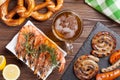 Beer mug, grilled shrimps, sausages and pretzel Royalty Free Stock Photo