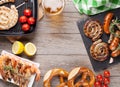 Beer mug, grilled shrimps, sausages and pretzel Royalty Free Stock Photo