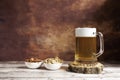 Beer mug with peanuts and almonds Royalty Free Stock Photo