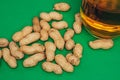 beer mug peanuts in shells bar alcohol green background Royalty Free Stock Photo