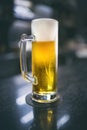 Beer mug served at a bar counter by a barman Royalty Free Stock Photo