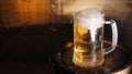 Beer mugs and barrel on a wooden background