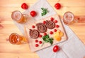 Beer mugs and cutting board with roasted sausages, cherry tomatoes, yellow pepper and fresh parsley on wooden table Royalty Free Stock Photo