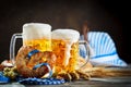 Beer mugs and pretzels on a wooden table. Oktoberfest. Beer festival.