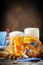 Beer mugs and pretzels on a wooden table. Oktoberfest. Beer festival. Royalty Free Stock Photo