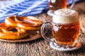 Beer and Oktoberfest. Draft beer pretzel and blue checkered tablecloth as traditional products for bavarian festival oktoberfest Royalty Free Stock Photo