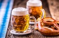 Beer. Oktoberfest.Two cold beers and pretzel. Draft beer. But draft. Golden beer. Golden however.