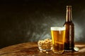 Beer and peanuts on an old wooden bar table Royalty Free Stock Photo