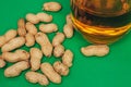 beer peanuts in shells bar alcohol green background Royalty Free Stock Photo