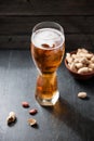 Beer and peanuts on the wooden background