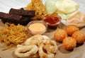 Beer plate-chicken wings, shrimp and potato chips, rye croutons, cheese balls, squid rings, Barbecue sauces and spice Royalty Free Stock Photo