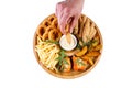 Beer plate fried ribs onion rings french fries fish nuggets on a wooden plate on a white background2