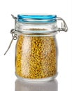 A beer pollen in a glass jar is on a white background. Natural remedy for immunity enhancement. Beekeeping