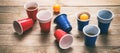 Beer pong. Plastic red and blue color cups and ping pong balls on wood Royalty Free Stock Photo