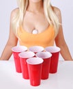 Beer pong. Red plastic cups with ping pong ball and blonde girl in tank top