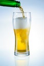 Beer is pouring from bottle into the glass Royalty Free Stock Photo