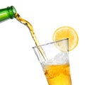 Beer pouring from bottle into glass with lemon Royalty Free Stock Photo