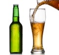 Beer pouring in a glass from a green bottle Royalty Free Stock Photo