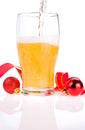 Beer pouring glass, Red ribbon and Christmas Balls Royalty Free Stock Photo