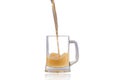 Beer pouring into half full glass over white background Royalty Free Stock Photo